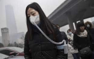 cinesi con la mascherina per lo smog